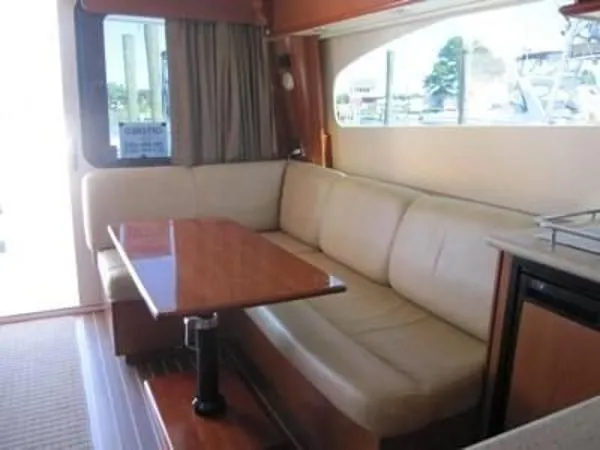 Slide: The Image of Interior of 2008 Luhrs 35C yacht with beige leather seating and wooden table. - 15