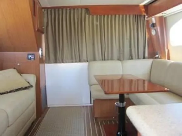 Slide: The Image of Interior of 2008 Luhrs 35C yacht with beige seating and wooden table. - 17