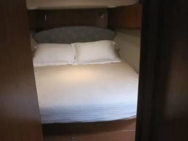 Slide: The Image of 2008 Luhrs 35C cabin bedroom with double bed and pillows. - 22