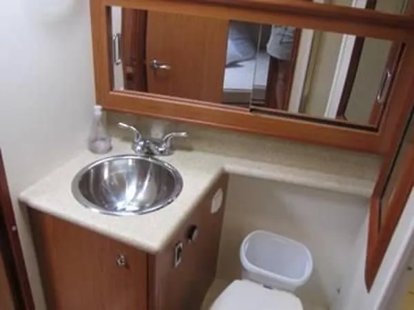 Slide: The Image of 2008 Luhrs 35C boat bathroom with sink, mirror, and toilet. - 26