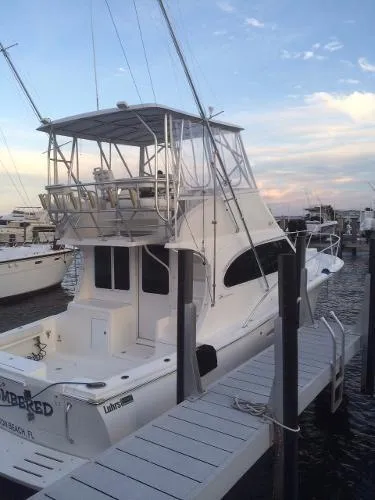 Slide: The Image of 2008 Luhrs 35C yacht docked at a marina during sunset. - 3