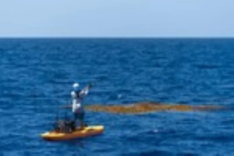 Slide: The Image of Person fishing on a 2023 Hobie Outback kayak in the ocean. - 2