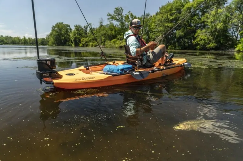 Slide: The Image of Man fishing from a 2023 Hobie Outback kayak on a calm lake. - 5