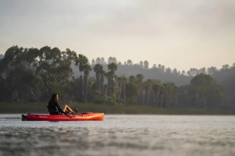 Slide: The Image of Person kayaking on a 2023 Hobie Revolution 11 in a serene lake. - 4