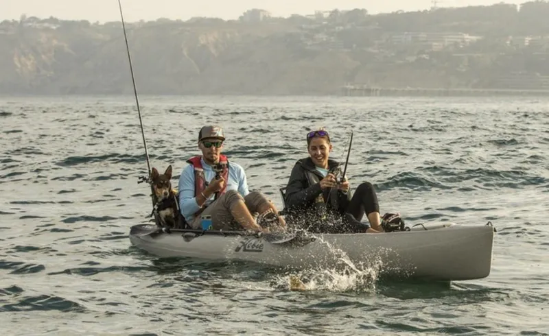Slide: The Image of Two people fishing on a 2022 Hobie Mirage Oasis kayak with a dog. - 5