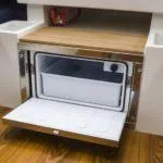 Slide: The Image of Compact fridge in 2025 Saffier SC 8M Cabin, featuring a sleek wooden countertop. - 12