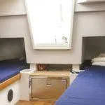 Slide: The Image of 2025 Saffier SC 8M Cabin interior with twin blue beds and skylight. - 9