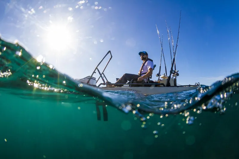 Slide: The Image of Angler fishing on a 2022 Hobie MIRAGE PRO ANGLER 14 kayak in sunny waters. - 3