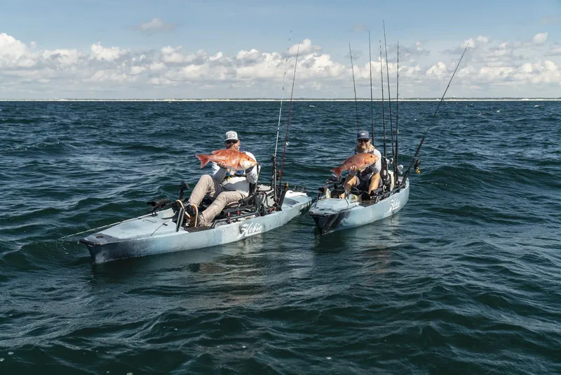 Slide: The Image of Two anglers on Hobie Mirage Pro Angler 14 kayaks with 360 Drive Technology, 2023, holding fish. - 12