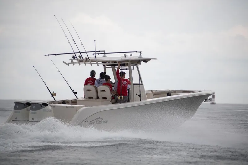 Slide: The Image of 2026 Sea Chaser 35 HFC boat cruising with fishing rods and passengers on board. - 1