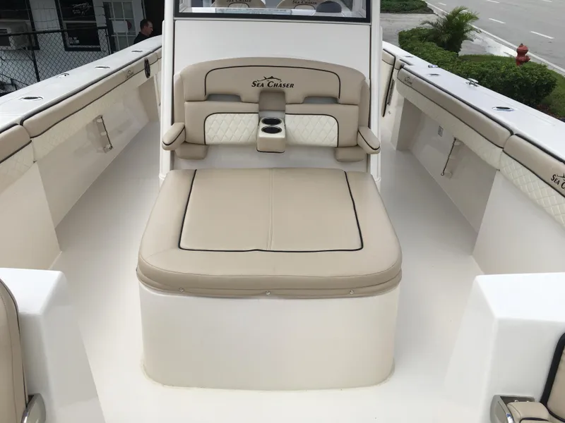 Slide: The Image of 2026 Sea Chaser 35 HFC boat interior with beige seating and cup holder. - 10