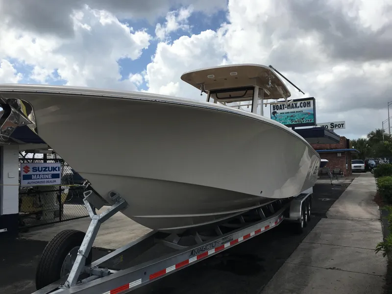 Slide: The Image of 2026 Sea Chaser 35 HFC boat on trailer under cloudy sky. - 12