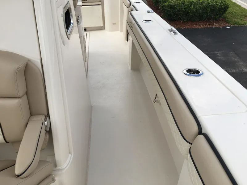 Slide: The Image of 2026 Sea Chaser 35 HFC boat interior with beige seating and white deck. - 14