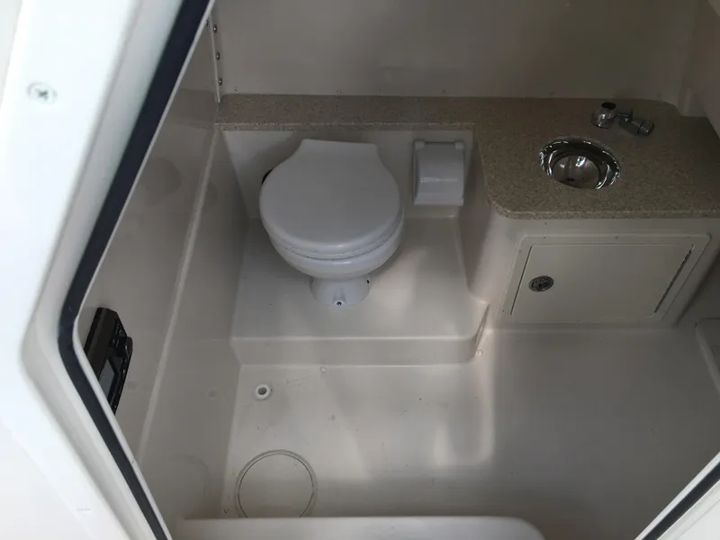 Slide: The Image of 2026 Sea Chaser 35 HFC boat bathroom with toilet, sink, and storage cabinet. - 15