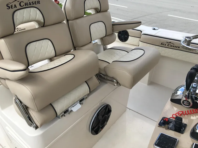 Slide: The Image of Luxury seating on 2026 Sea Chaser 35 HFC boat with beige upholstery and modern controls. - 19