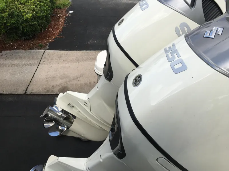 Slide: The Image of Twin outboard motors on a 2026 Sea Chaser 35 HFC boat, parked on a driveway. - 32