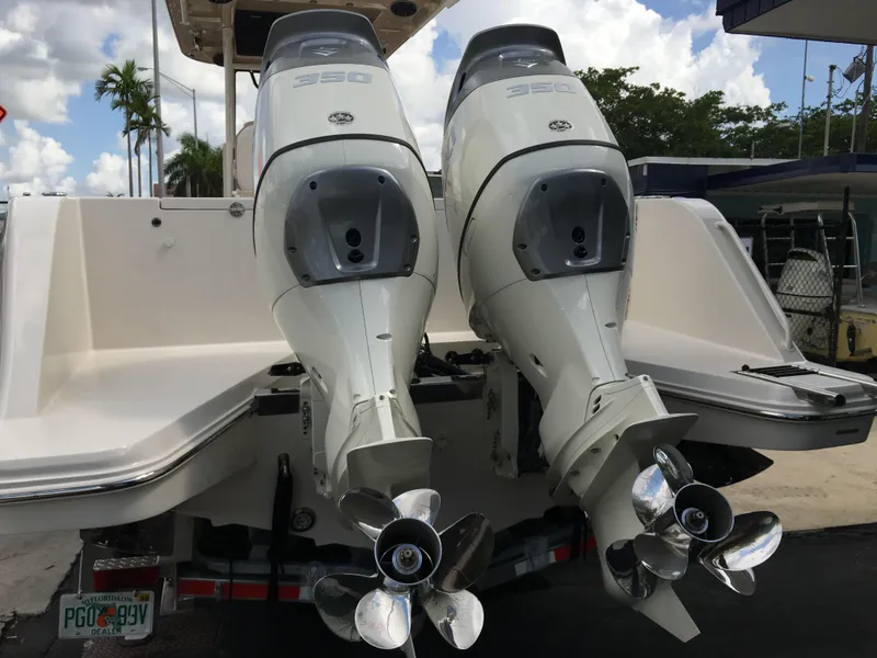 Slide: The Image of 2026 Sea Chaser 35 HFC boat with dual outboard engines, docked under a cloudy sky. - 33