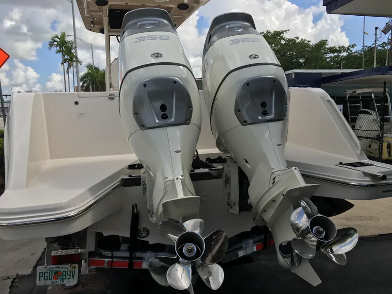 Slide: The Image of Twin outboard engines on a 2026 Sea Chaser 35 HFC boat, docked under a cloudy sky. - 34