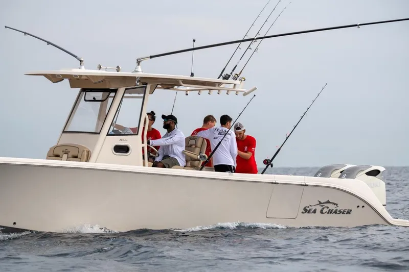 Slide: The Image of 2026 Sea Chaser 35 HFC boat with people fishing in open water. - 36