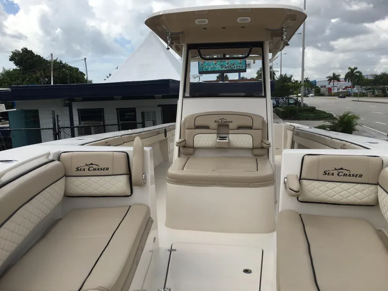 Slide: The Image of 2026 Sea Chaser 35 HFC boat interior with beige seating and helm station. - 5