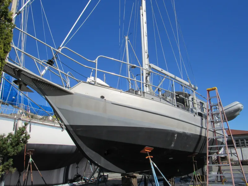 The Image of 2009 Custom Pilothouse Cutter sailboat on dry dock with clear blue sky. - 0