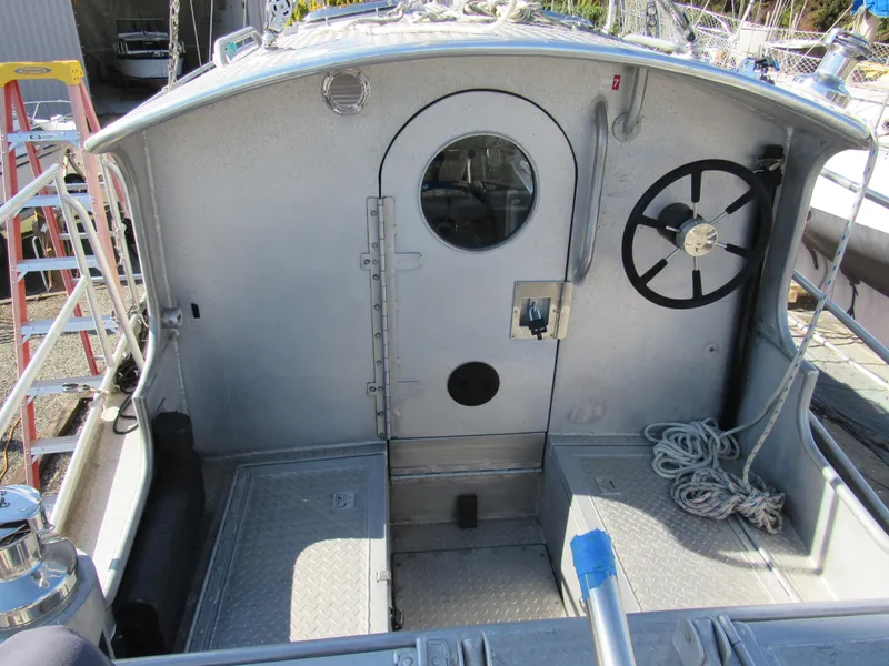 Slide: The Image of Custom 2009 Pilothouse Cutter cockpit with wheel, ropes, and metal door. - 15
