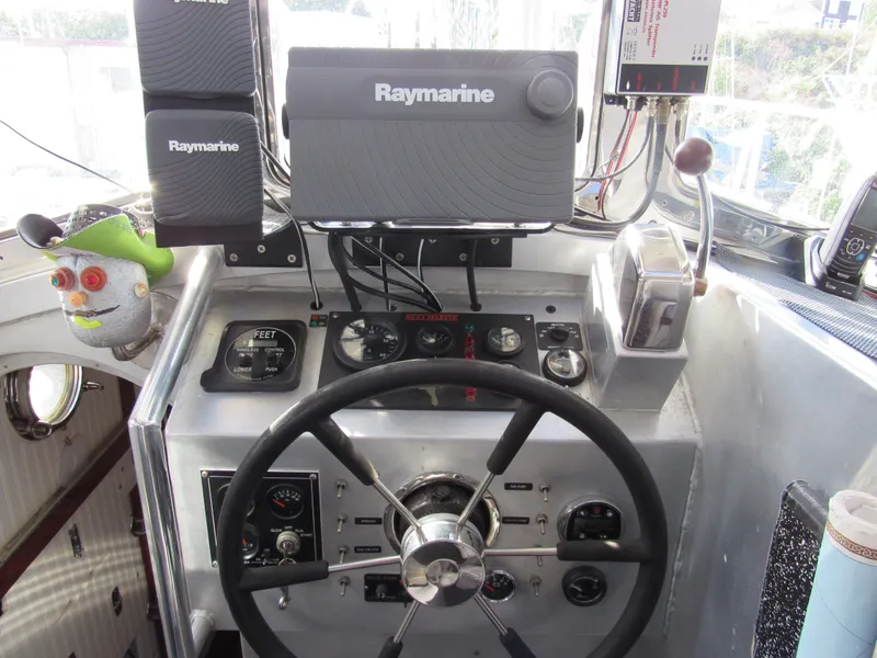 Slide: The Image of Pilothouse Cutter 2009 helm with Raymarine equipment and steering wheel. - 18