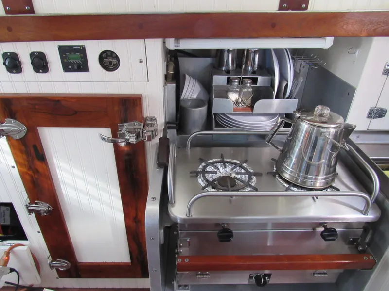 Slide: The Image of Compact galley kitchen in 2009 Custom Pilothouse Cutter with stove and kettle. - 20