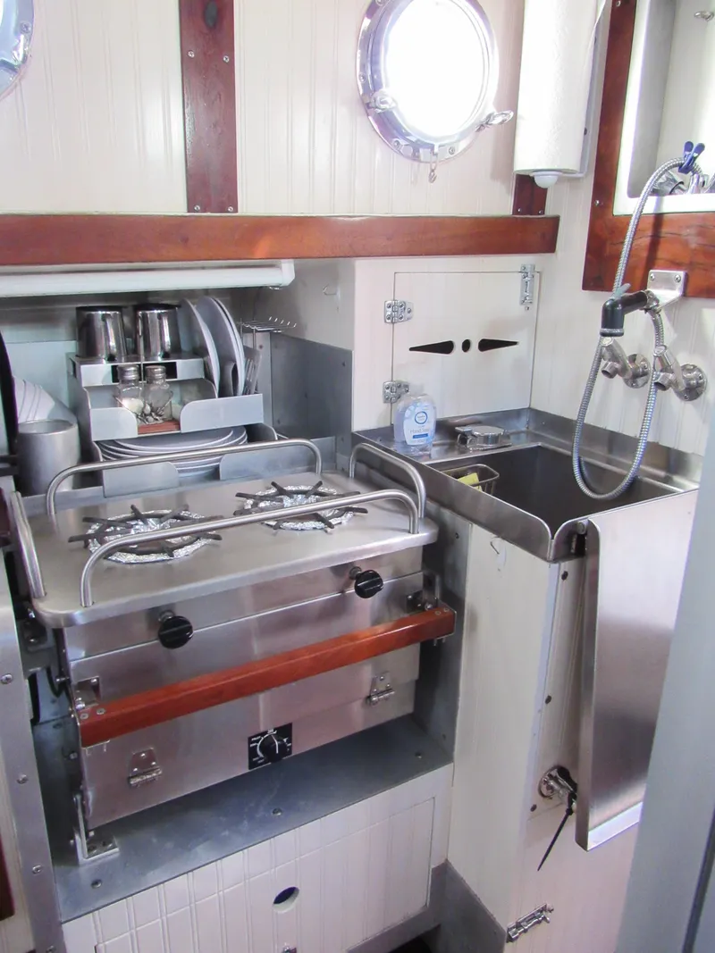 Slide: The Image of Compact galley kitchen in 2009 Custom Pilothouse Cutter with stove and sink. - 22