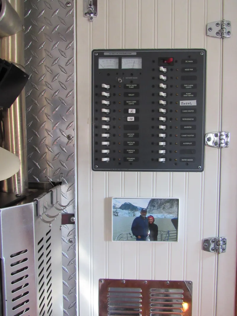 Slide: The Image of Electrical panel on 2009 Custom Pilothouse Cutter with photo and metal accents. - 26
