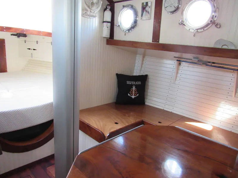 Slide: The Image of Interior of 2009 Custom Pilothouse Cutter with wooden furnishings and nautical decor. - 28