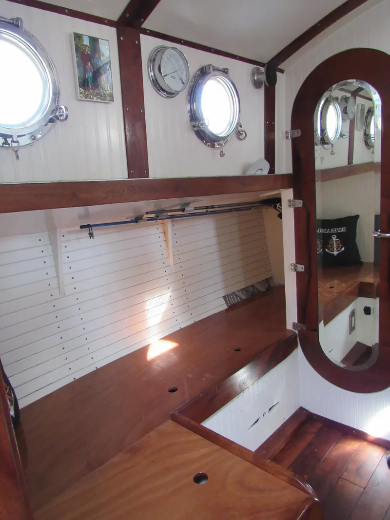 Slide: The Image of Interior of 2009 Custom Pilothouse Cutter with wooden finishes and portholes. - 29