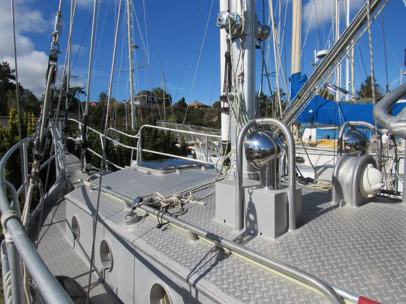 Slide: The Image of Custom Pilothouse Cutter 2009 sailboat deck with rigging and winches under clear blue sky. - 3