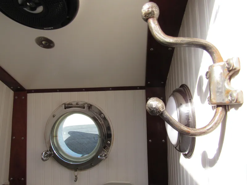 Slide: The Image of Interior of 2009 Custom Pilothouse Cutter with porthole and brass hook. - 32