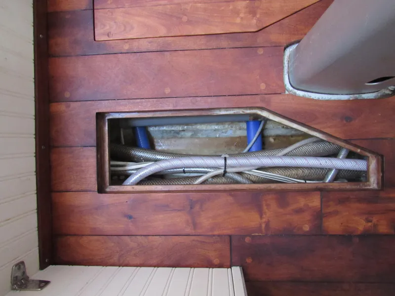 Slide: The Image of Wooden deck of 2009 Custom Pilothouse Cutter with exposed wiring and pipes. - 33
