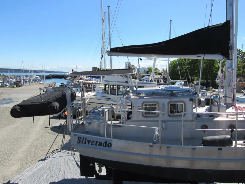 Slide: The Image of 2009 Custom Pilothouse Cutter "Silverado" docked at marina under clear blue sky. - 36