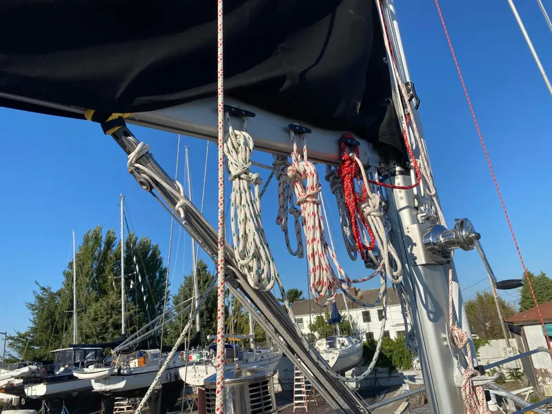 Slide: The Image of Sailboat rigging on a 2009 Custom Pilothouse Cutter, with ropes and mast against a clear sky. - 41