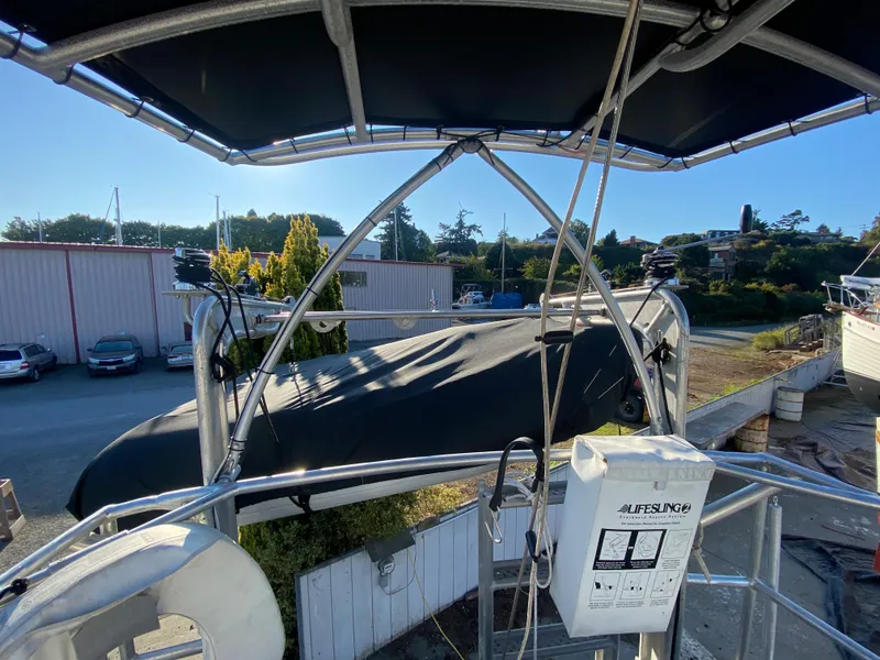 Slide: The Image of 2009 Custom Pilothouse Cutter with covered deck, docked in a marina under clear skies. - 43