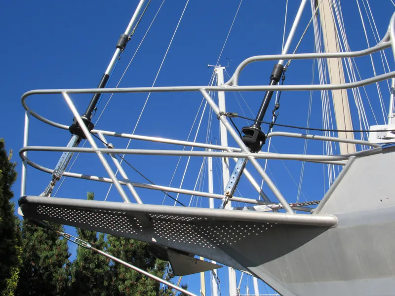 Slide: The Image of Custom Pilothouse Cutter 2009 bow with metal railings against clear blue sky. - 5