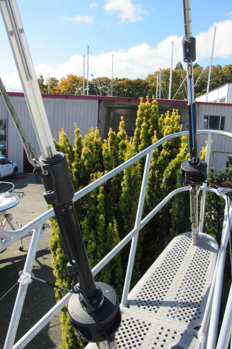Slide: The Image of 2009 Custom Pilothouse Cutter deck with railing and lush greenery in the background. - 6