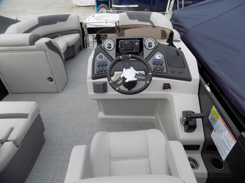 Slide: The Image of 2023 Sylvan L3 CLZ boat interior with modern helm and comfortable seating. - 5