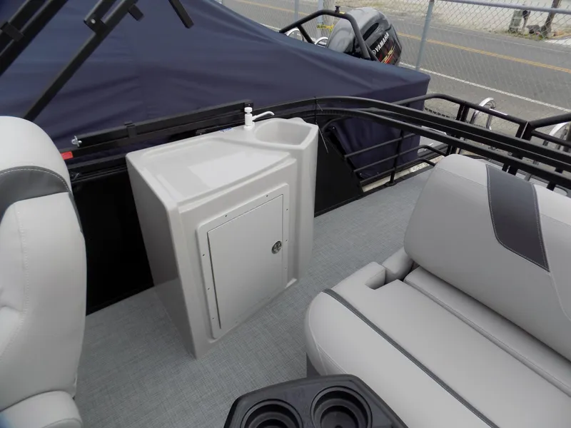 Slide: The Image of 2023 Sylvan L3 CLZ boat interior with seating, sink, and storage cabinet. - 6