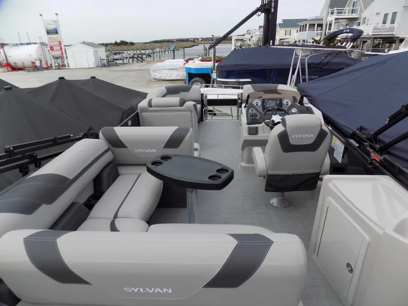 Slide: The Image of 2023 Sylvan L3 CLZ pontoon boat interior with plush seating and modern helm. - 7