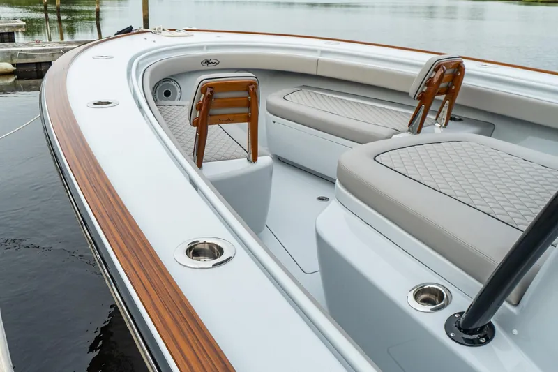 Slide: The Image of 2025 Valhalla Boatworks V-33 interior with seating and wood accents. - 11