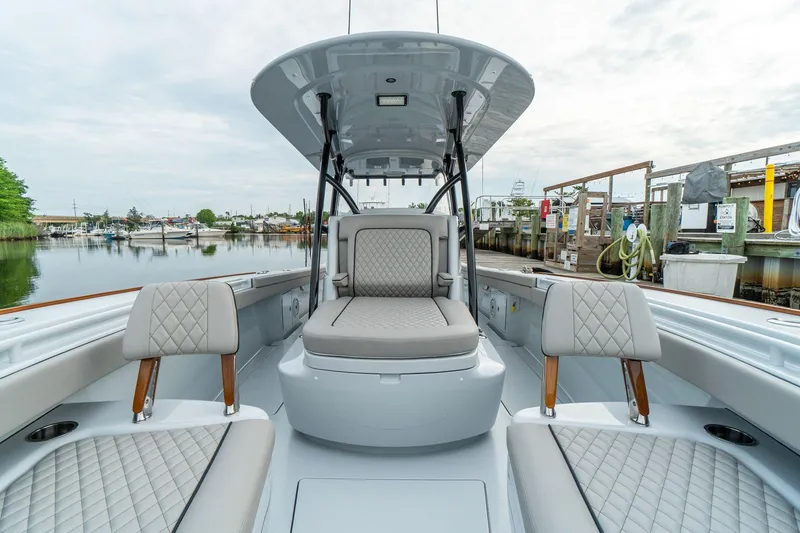 Slide: The Image of 2025 Valhalla Boatworks V-33 interior with luxurious seating at a marina. - 13