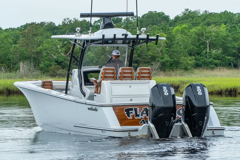 Slide: The Image of 2025 Valhalla Boatworks V-33 with dual engines cruising on a calm river. - 3