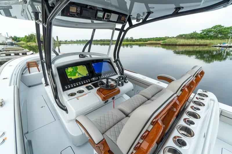 Slide: The Image of 2025 Valhalla Boatworks V-33 center console with advanced navigation system on a serene waterway. - 5