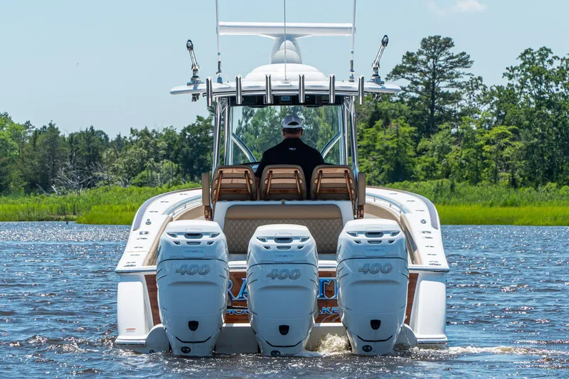 Slide: The Image of 2025 Valhalla Boatworks V-37 with quad 400 engines cruising on a lake. - 4
