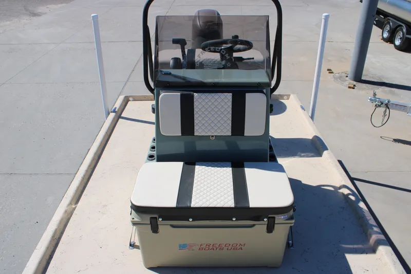 Slide: The Image of 2026 Freedom 14 CHIQUITA boat console with seating and steering wheel. - 12