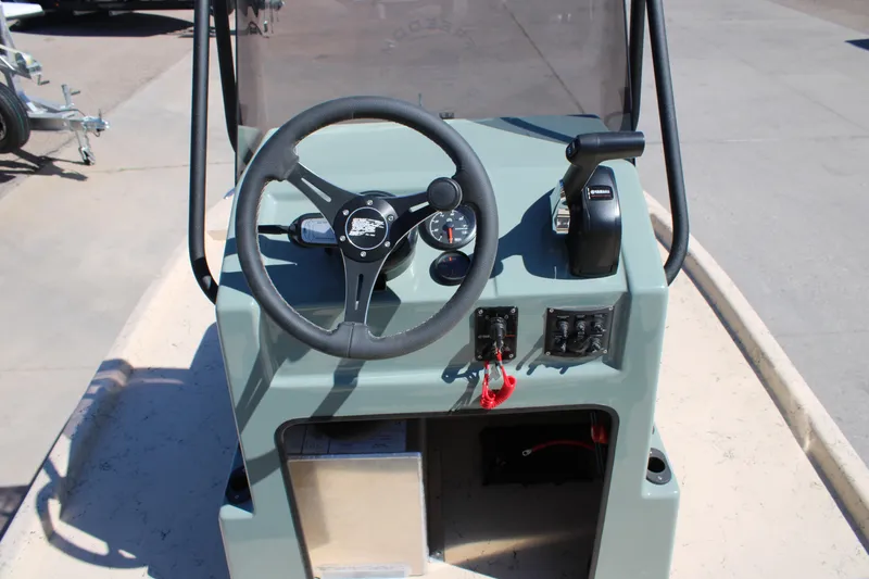 Slide: The Image of Steering console of 2026 Freedom 14 CHIQUITA boat with controls and gauges. - 15